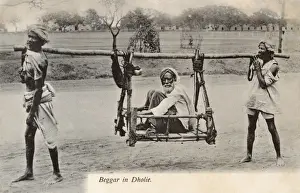 Bearers Prints: Dhule, India - A beggar is carried in a two-man litter