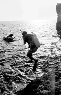 Anchored Prints: Diver jumping into the sea off the coast of Malta