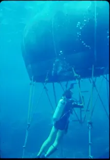Diver with underwater house off the coast of Malta