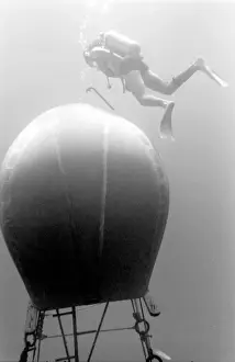 Diver with underwater house off the coast of Malta