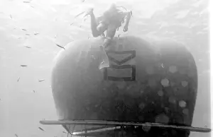 Diver with underwater house off the coast of Malta