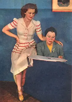 Dolly Tree and Mary Howard discussing the costumes