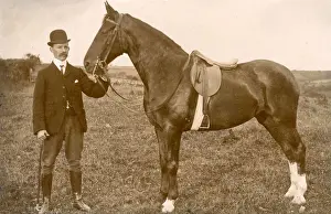 Well dressed man with saddled horse