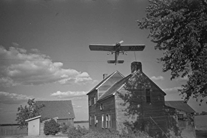 Dusting plane hedge-hopping after spraying swath on beanfiel Dusting plane hedge-hopping after spraying swath on beanfiel