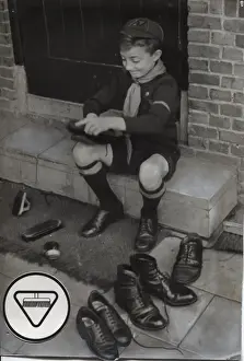 Brushing Prints: Dutch cub scout polishing shoes, Netherlands