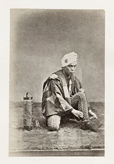 Early Japanese portrait: man tying shoe laces