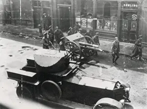 Easter Rising, 1916. Soldiers with gun and armoured car in the streets of Dublin outside Dowling or Dowling's pub. Date: 1916