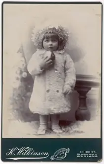 Edwardian girl in a white fur coat and hat