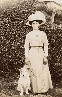 Edwardian woman with a terrier in a garden