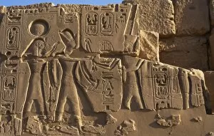 Egyptian Art. Karnak. The Pharaoh surrounded by two diviniti