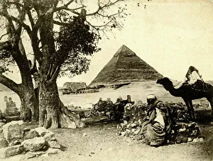 Egyptian and camel with a pyramid behind