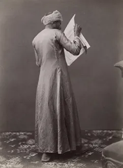 Egyptian man reading a newspaper, c. 1880 s