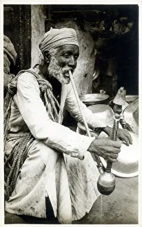 Smoker Prints: Egyptian man smoking a long-stemmed Hookah pipe