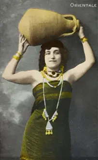 An Egyptian woman holding aloft a large pottery jar