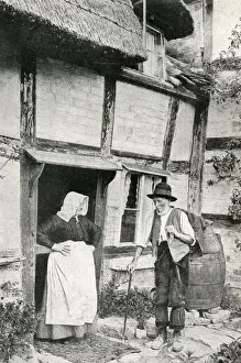 Elderly couple outside cottage, Little Comberton, Worcs