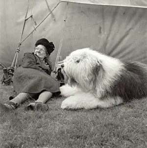 Carta Prints: Elderly lady in hat and coat taking a break at dog show in northern England with her dog