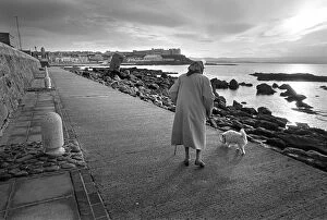 Cold Gallery: An elderly lady with white dog Portstewart, Northern Ireland