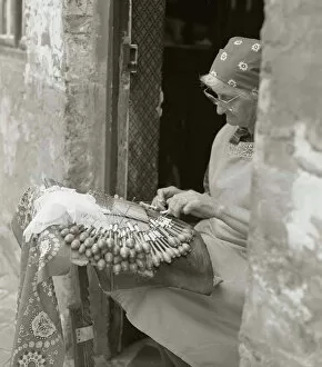 Elderly Collection: Elderly woman making lace in an open doorway