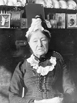 Bonnet Collection: Elderly woman in front of a Welsh dresser, Mid Wales