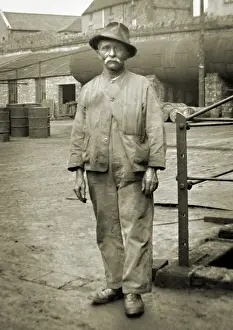 Containers Prints: Elderly workman in a yard
