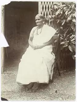 Elegant elderly Indian woman sitting on a chair
