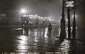 The Embankment, London on wet night with Policeman and Trams
