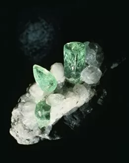 Emerald crystals and cut stone