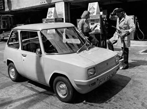 Puzzled Collection: Enfield 8000 Electric Car at a petrol station