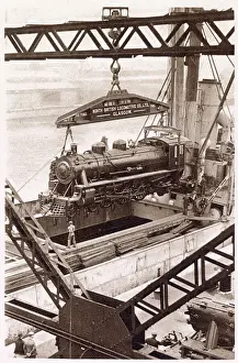 One of the eight engines built under contract by the North British Locomotive Company, Ltd, being shipped aboard the M. V Beldis. Date: 1933