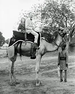 Stirrups Prints: European man and daughter on camel, India