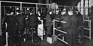 Examining Passports at Ellis Island, New York, 1911