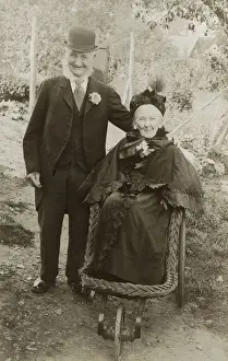 Lapel Prints: Extremely jolly elderly couple - Granny in a bath chair
