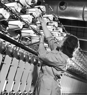 Spool Gallery: Factory employee checks large Spinning Machine