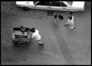 Family with cart in street, Valencia, Spain