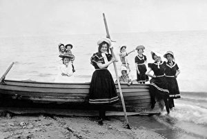 Family with children in bathing suits on a boat on the beach Family with children in bathing suits on a boat on the beach