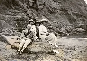Images Dated 31st October 2018: Family group sitting on a beach at the seaside
