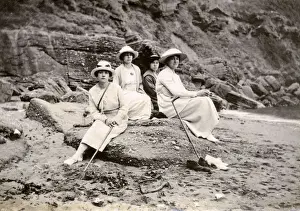 Family group sitting on a beach at the seaside