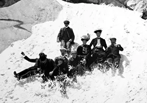 Family on holiday glissading in the snow, Victorian period