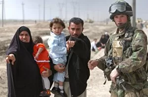 Digital Collection: A family of Iraqi civilians seek the help of a soldier