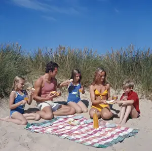 Enjoying Prints: Family of five with picnic on beach