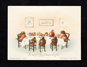 Family of robins at a table on a Christmas card