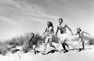 Summer Gallery: Family running across sand dunes
