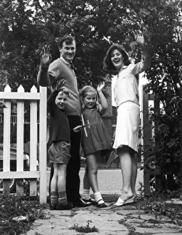 Family Waving at Gate