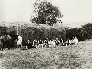 Feed Gallery: Farm workers resting beside a haystack, Somerset