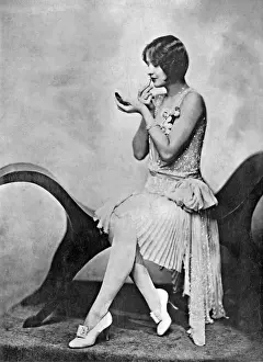 Fashionable woman applying lipstick