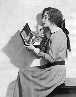 Applying Gallery: Fashionable woman applying lipstick