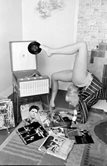 Double Collection: Female contortionist Diana Gaye playing records