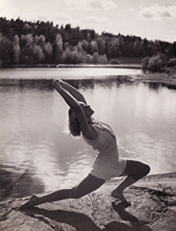 Gymnast Gallery: Female gymnast by lake stretch