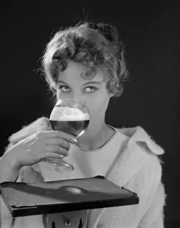 Female model (Gillian Watt) holding up a glass of beer