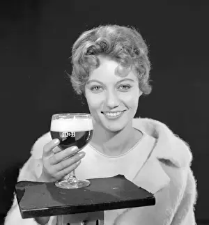 Female model (Gillian Watt) holding up a glass of beer
